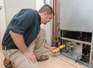 Worker Completing Winter Furnace Maintenance