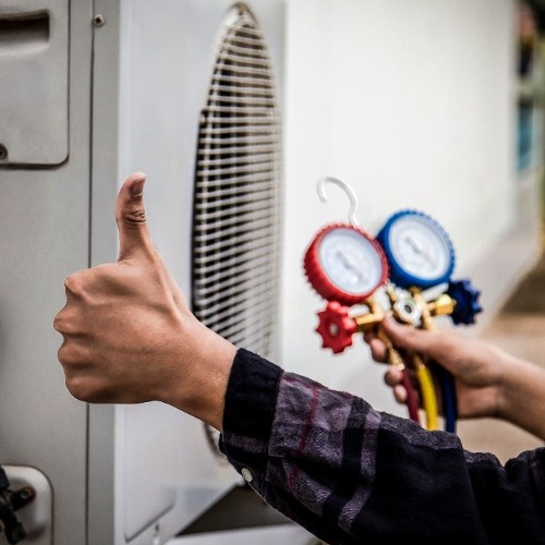 HVAC repairman performing maintenance on a unit