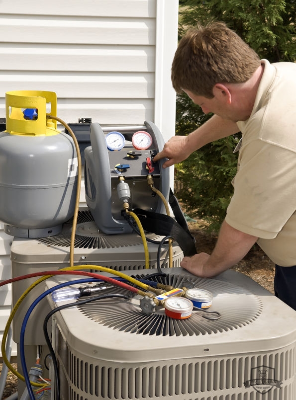 A Man Recharging AC Refrigerant.